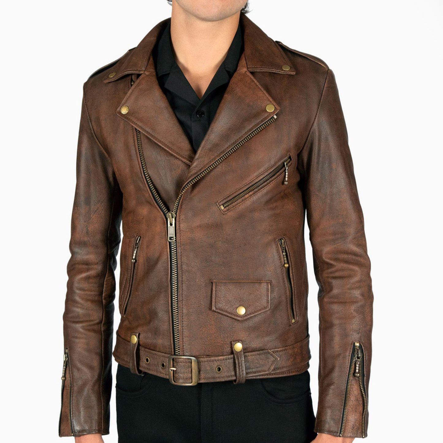 Close-up of vintage brown leather biker jacket showing belt, zipper, and aged leather texture