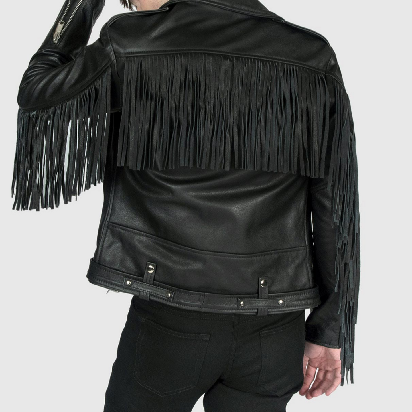 Side profile of men's black motorcycle leather jacket with fringe details on arms and slim fit cut
