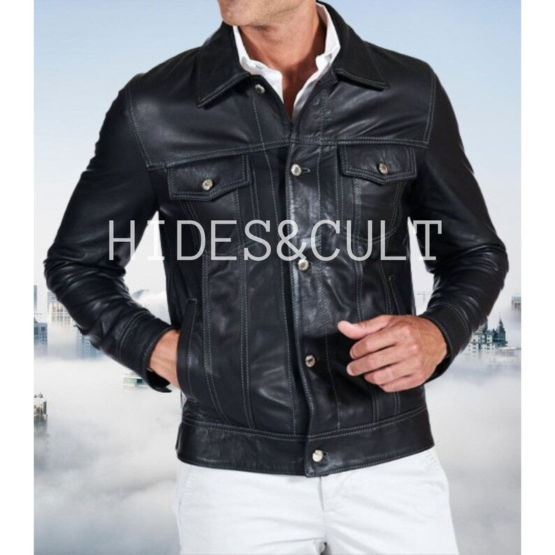 Stylish man wearing a black leather jacket in a trucker style, front view, highlighting the white stitching details and chest pockets.