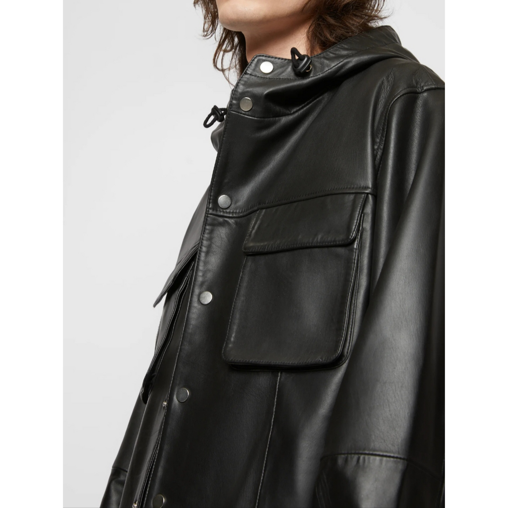 Close-up of men's black bomber style hooded genuine leather sweatshirt, highlighting the premium leather texture and detailed stitching – Hides & Cult