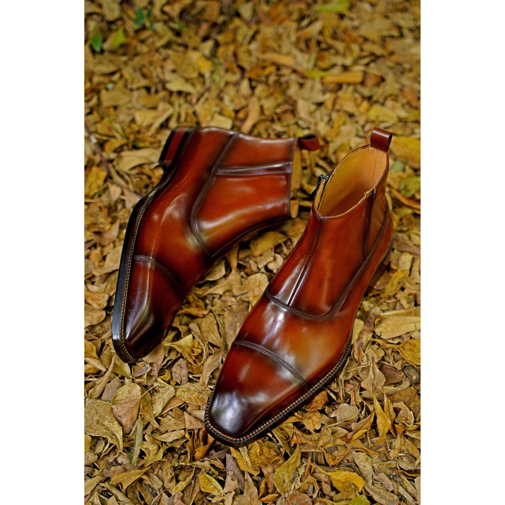 Elegant brown Chelsea boots for men with polished finish – perfect pairing with tailored black pants for a sleek urban look.