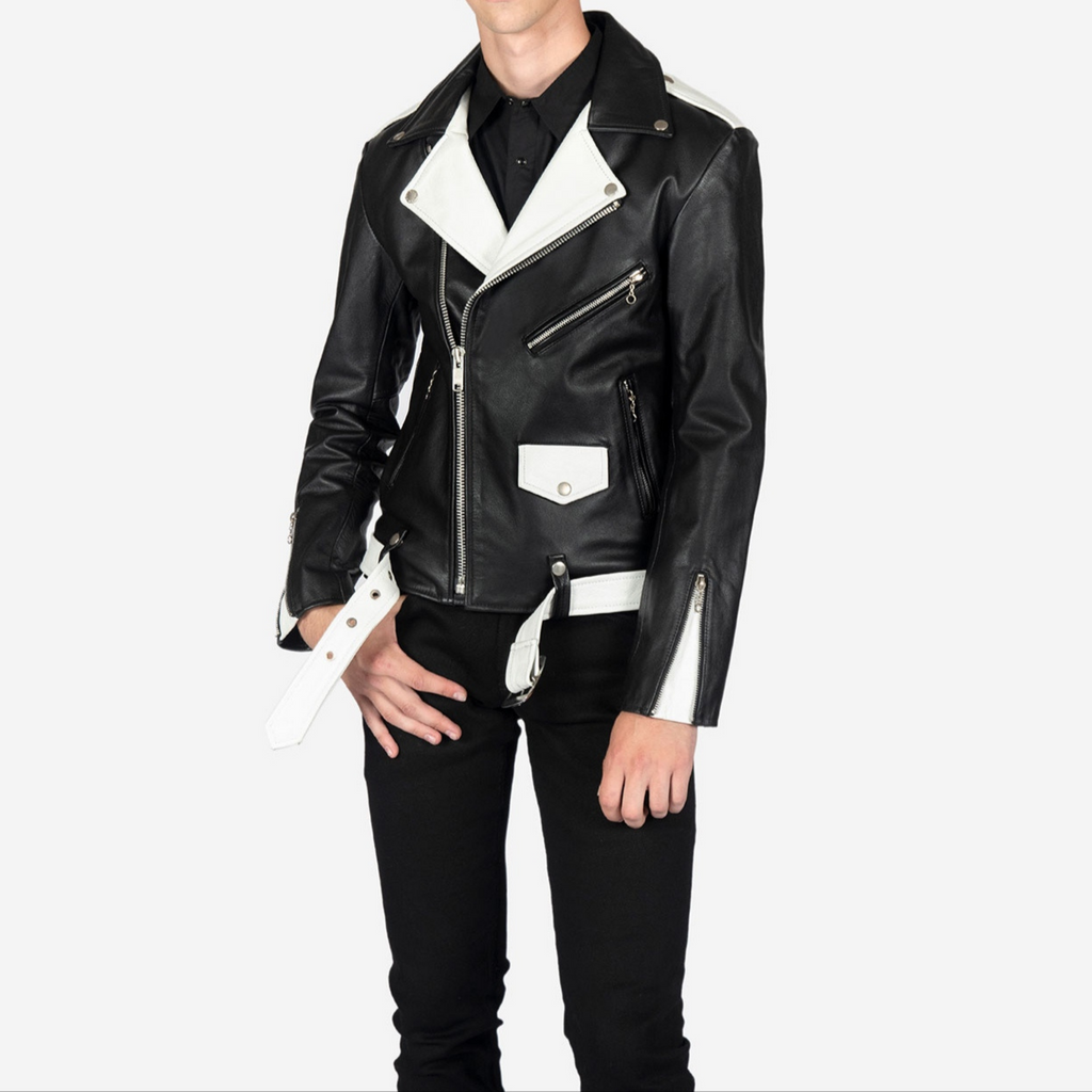 Full view of model wearing men's black and white two tone slim fit biker leather jacket with belted waist, zippered cuffs, and snap collar details
