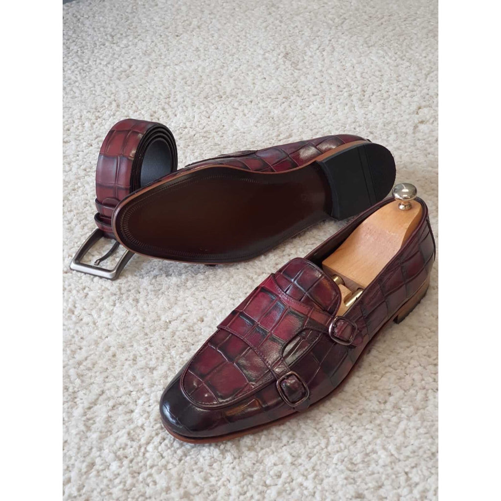 Pair of burgundy croc-print leather monk strap loafers – handcrafted shoes offering a rich finish and premium construction.
