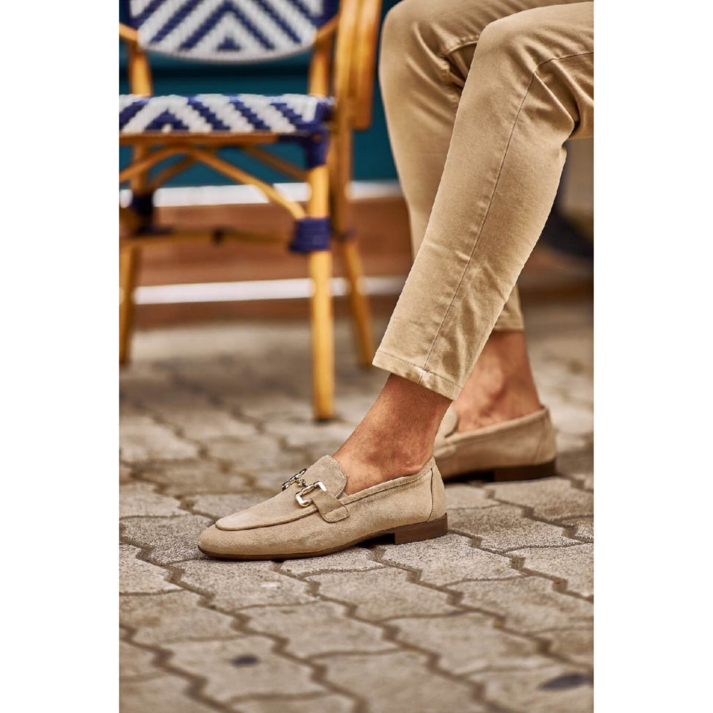 Close-up of handcrafted beige suede loafers with elegant stitching and sleek horsebit hardware – ideal for modern summer style.