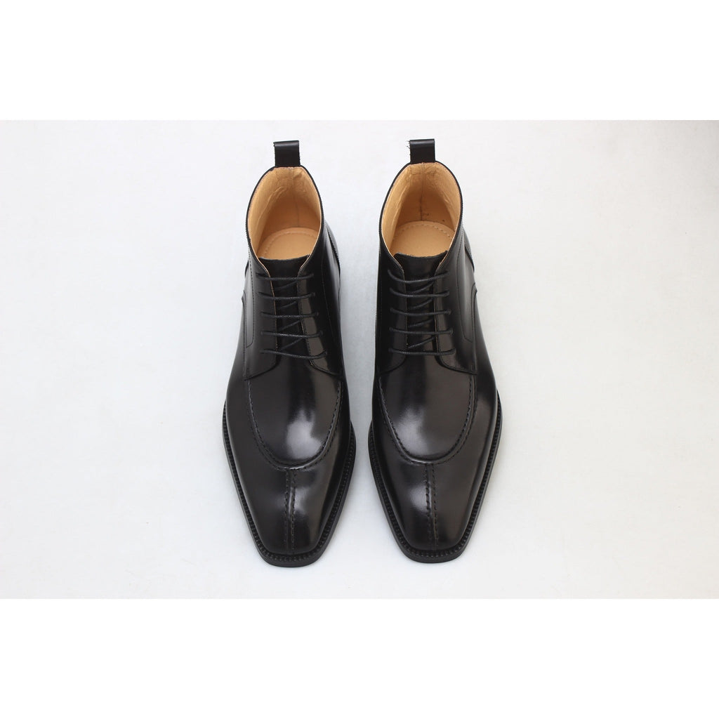 Top view of polished black dress boots for men – timeless leather footwear with premium finishing.