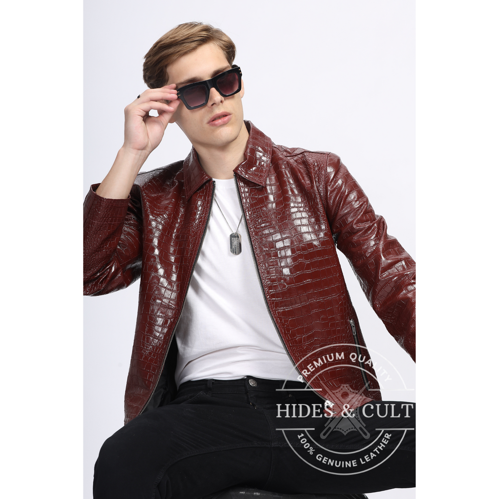 Model seated showcasing stylish crocodile-textured leather jacket in deep burgundy, handmade by Hides & Cult