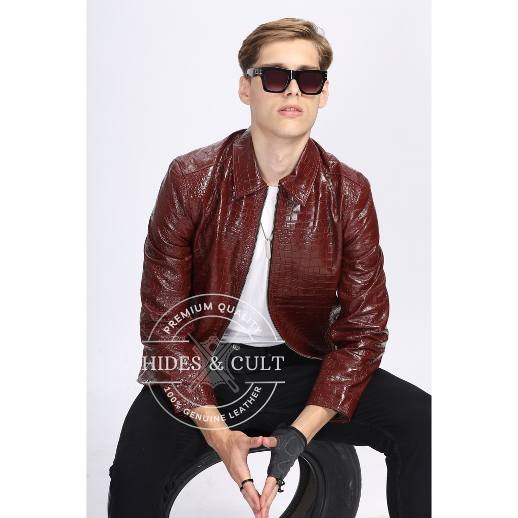 Model seated showcasing stylish crocodile-textured leather jacket opened zipped in deep burgundy, handmade by Hides & Cult