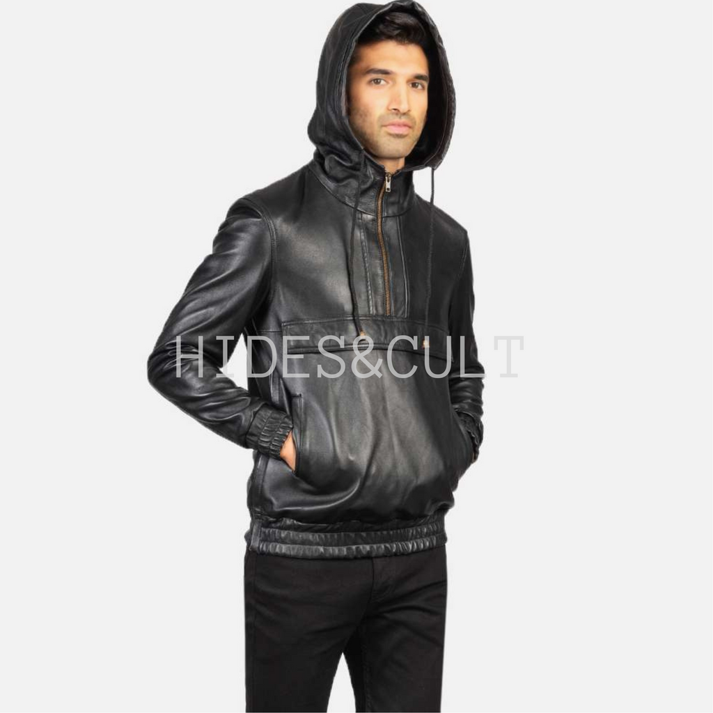 Model with hood on and hands in pocket, showcasing black leather hoodie jacket by Hides & Cult with relaxed streetwear fit.