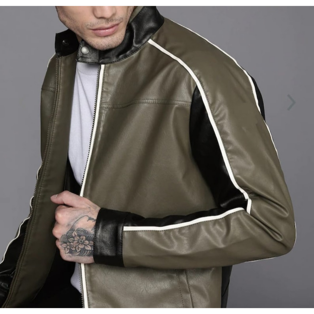 Stylish man wearing a unique two-tone leather jacket with white piping, demonstrating casual sophistication while seated.

