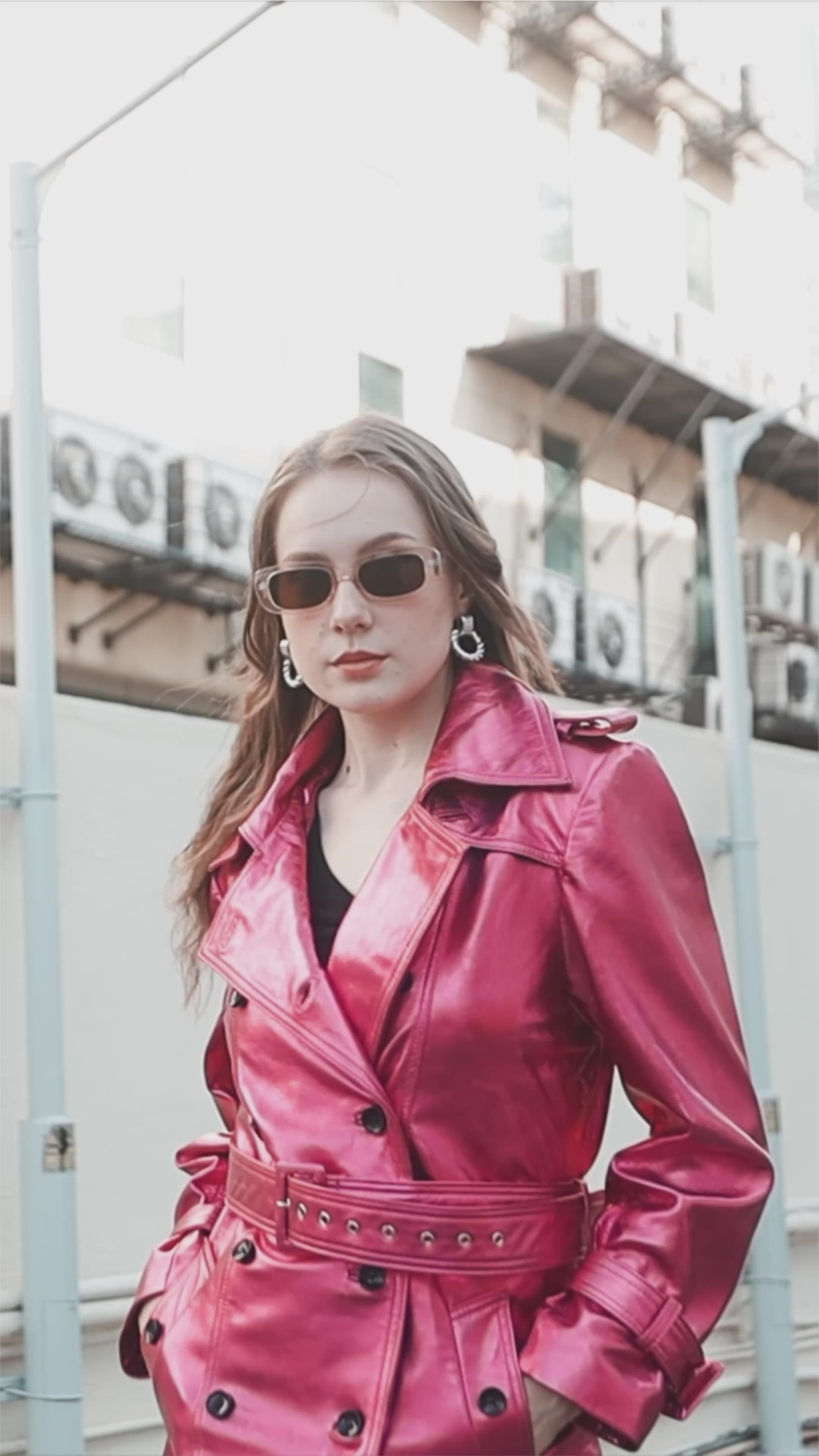 video of Model wearing womens pink metallic foil leather trench coat double breasted 