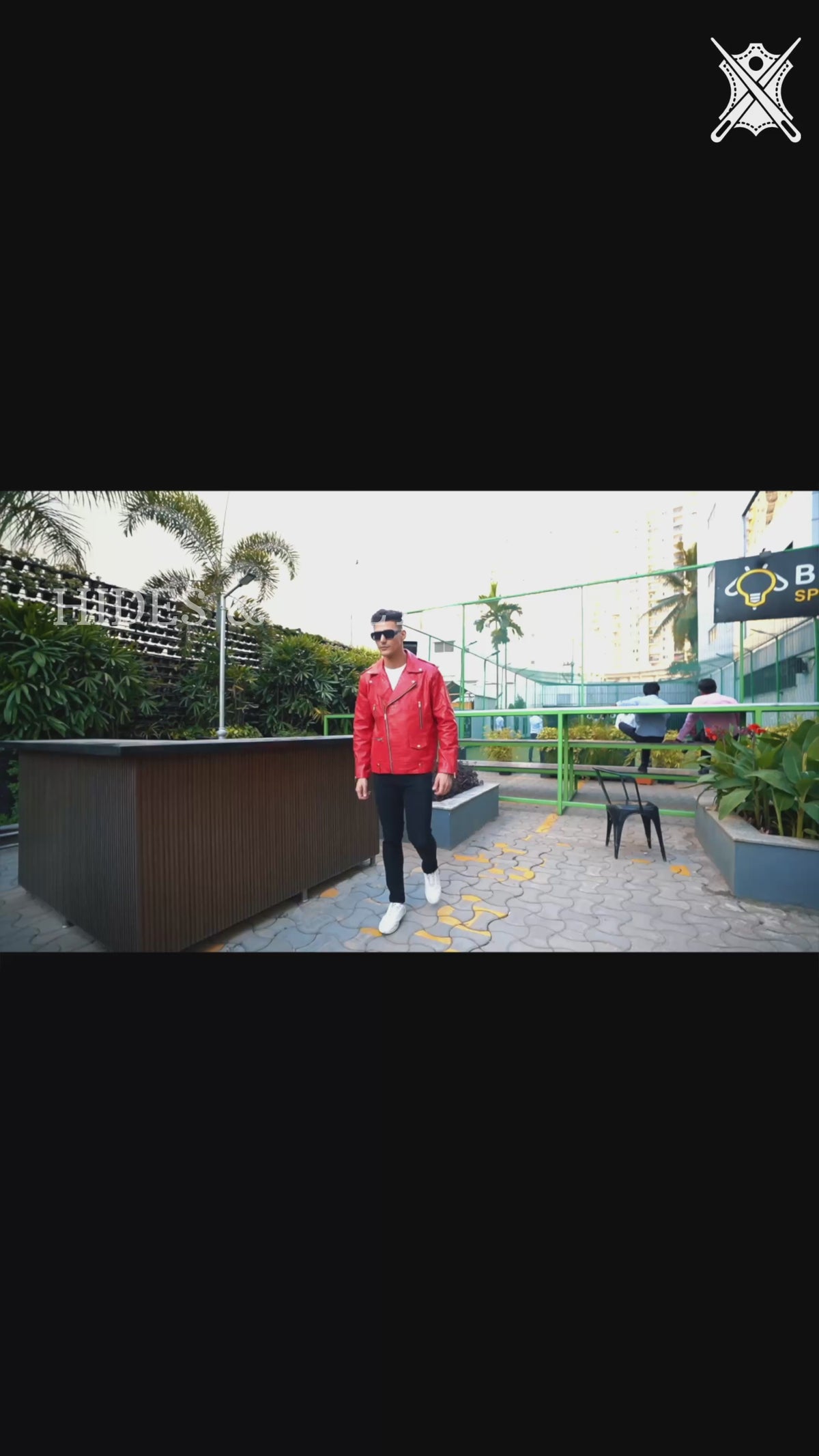 Video of model wearing men's red croc-embossed motorcycle leather jacket showing 360° view, fit, and textured crocodile effect in motion